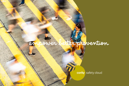 A woman stands on a crosswalk as blurred people walk by; text reads empower better prevention and address safety risks.