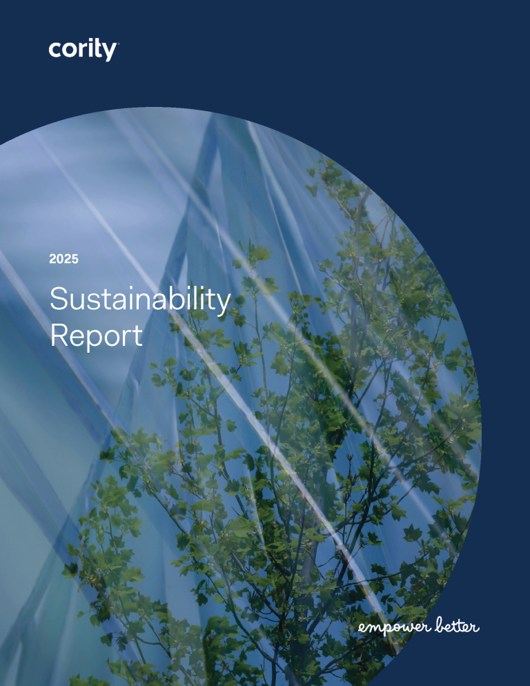 Cover of the 2025 Cority Sustainability Report, featuring green tree branches reflected on a glass building against a blue sky. “Empower better” is written in cursive at the bottom right—subscribe to our newsletter for updates.