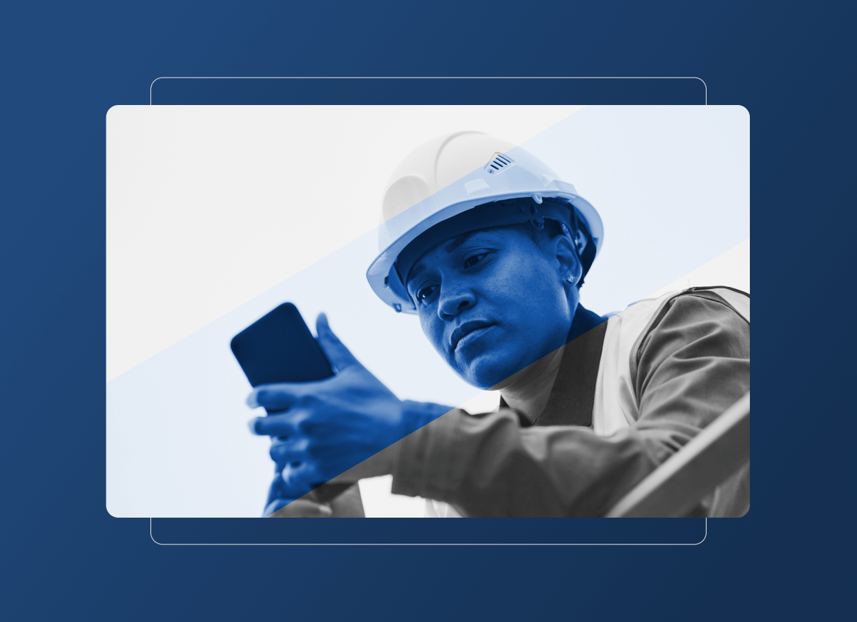 A person wearing a hard hat and safety vest, representing the construction industry, looks at a smartphone with focus. The image features a blue color overlay and graphic design elements in the background.