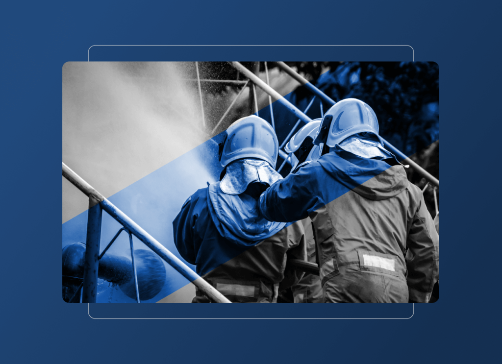 Two firefighters in protective gear and helmets spray water from a hose, battling a fire. Blue graphic overlays and a dark blue background emphasize teamwork, emergency response, and their vital role in the Energy Industry.