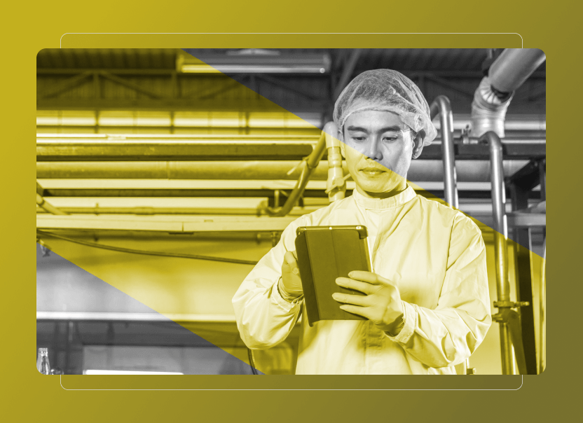 A person in protective clothing and a hairnet stands in an industrial setting, using a tablet device with Safety Cloud features. Yellow geometric shapes overlay the black-and-white photo.