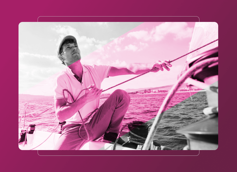 A person wearing a cap sits on a sailboat, pulling on a rope with one hand while looking upward. The image features a pink overlay and is set against water and sky, capturing the spirit of adventure and sustainability cloud innovation.