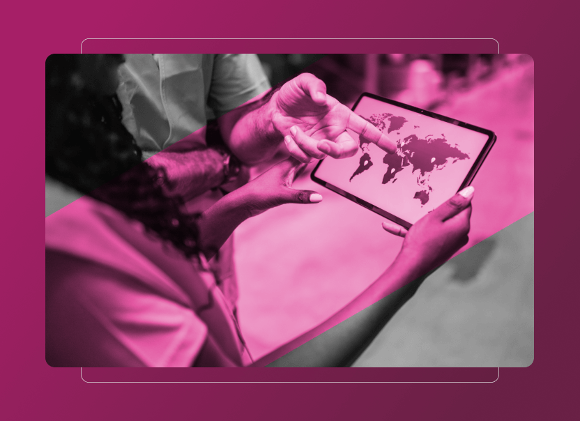 Two people hold and point at a tablet displaying a world map, highlighting Sustainability Cloud insights. The image features a pink overlay and blurred background, focusing on the tablet and their hands.